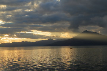 Naklejka na ściany i meble 秋、夕暮れの支笏湖と夕日 ( Evening view at Lake Shikotsu, Chitose, Hokkaido, Japan )