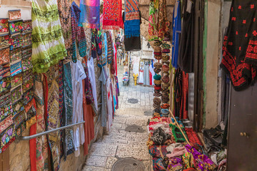 Arab bazaar with clothes located on a quiet street of the Old City in Jerusalem, Israel