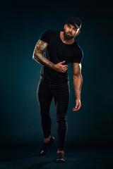 Strong and fit man bodybuilder. Sporty muscular guy athlete. Sport and fitness concept. Men's fashion in full height.