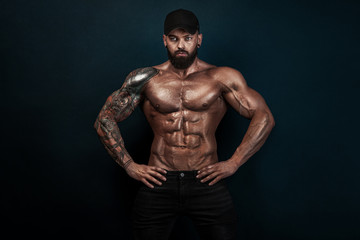Obraz na płótnie Canvas Strong and fit man bodybuilder. Sporty muscular guy athlete. Sport and fitness concept. Men's fashion.