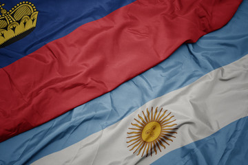 waving colorful flag of argentina and national flag of liechtenstein.