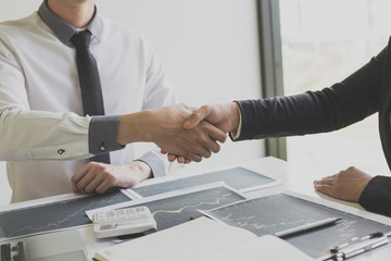 Shake hands of businessmen, young men, the company's financial accountants join hands to congratulate the owners of successful companies that are very profitable, financial business