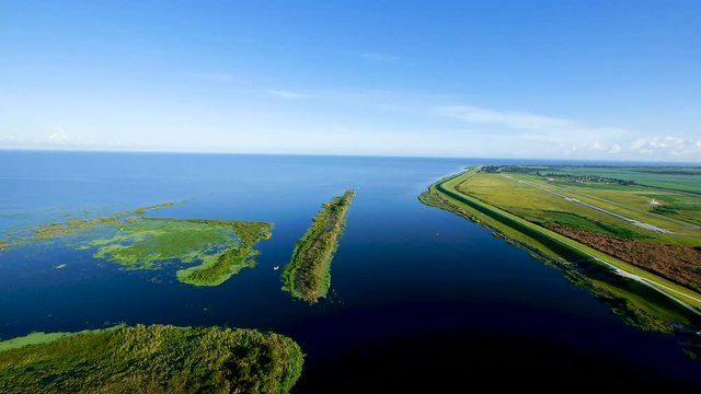 Flying over grassy islands on Lake Okeechobee in a paramotor glider