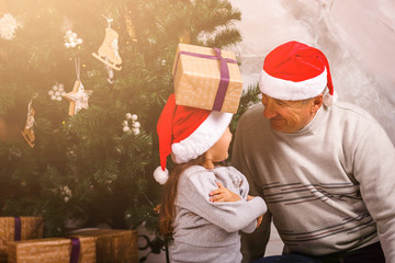 Grandfather and child in Santa hats