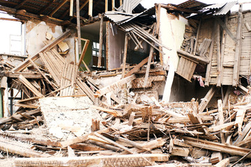 Destruction of an old wooden abandoned house. Demolition of the house