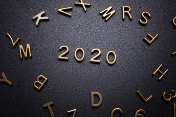 Year 2020 sign on a black desk.