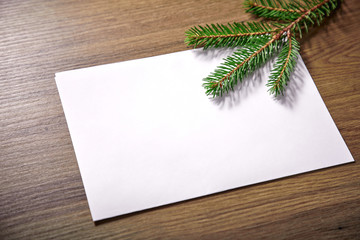 empty paper  with fir branches and cones on the wooden background