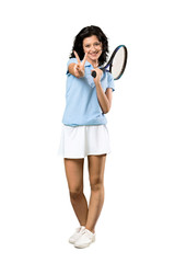 A full-length shot of a Young tennis player woman smiling and showing victory sign over isolated white background