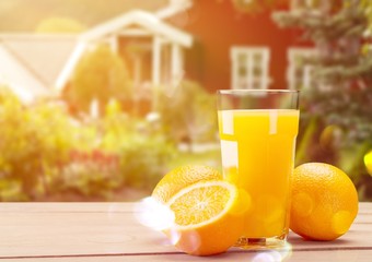 Orange juice and slices of orange on wooden table