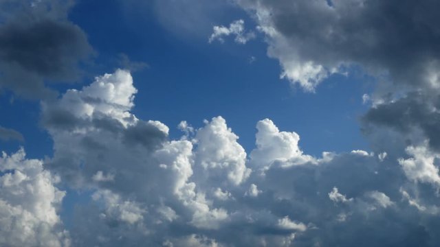 Storm clouds are brewing in this time-lapse clip. Beautiful blue sky with cumulus congestus clouds on a mostly sunny day.