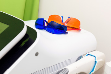 Orange goggles for laser hair removal. Eye protection from flashes.