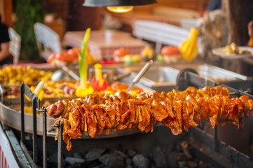 Grilled shashlik is prepared in a market. Concept: food on vacation