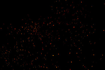 Burning red hot sparks fly from large fire in the night sky. Beautiful abstract background on the theme of fire, light and life. - Powered by Adobe