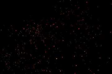 Foto op Aluminium Burning red hot sparks fly from large fire in the night sky. Beautiful abstract background on the theme of fire, light and life. © Torkhov