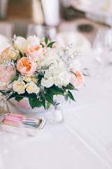 Fine wedding flower table arrangement at reception, pink, white and orange peonies, expensive wedding flowers