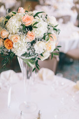 Fine wedding flower table arrangement at reception, pink, white and orange peonies, expensive wedding flowers