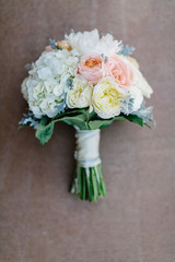 Modern pink and white wedding flower bouquet with roses, hydrangea, and peonies
