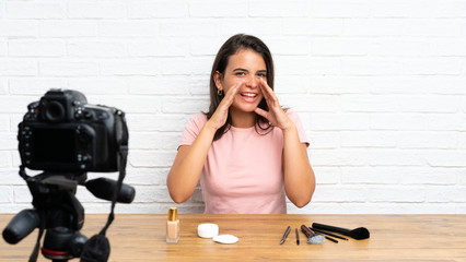Young girl recording a video tutorial shouting with mouth wide open