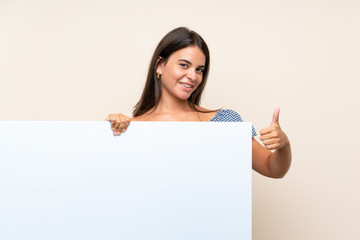 Young girl over isolated background holding an empty white placard for insert a concept