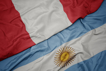 waving colorful flag of argentina and national flag of peru.