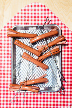 Skewered Hot Dogs on Red and White Picnic Blanket