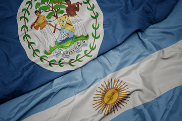 Obraz na płótnie Canvas waving colorful flag of argentina and national flag of belize.