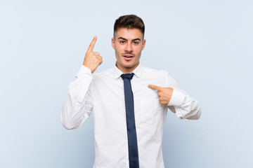 Handsome businessman over isolated blue background with surprise facial expression