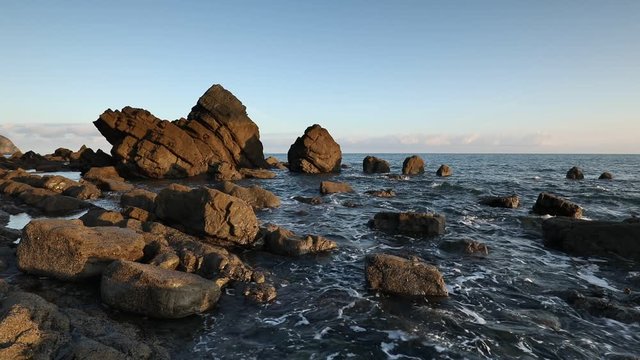 view of the rugged coastline at mouthmill beach, north devon with gentle waves