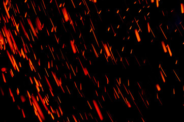 Abstract motion blur light background of particles. Red sparks.