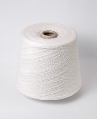 bobbin of yarn on a white background. Side view.Textile reel on isolated white background.
