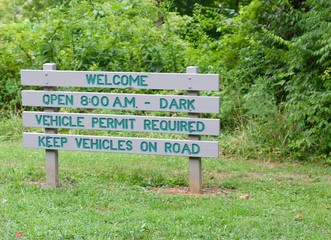 A close view of the small park information sign.