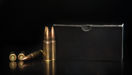 Bullet isolated on black background with reflexion. Rifle bullets close-up on black back....