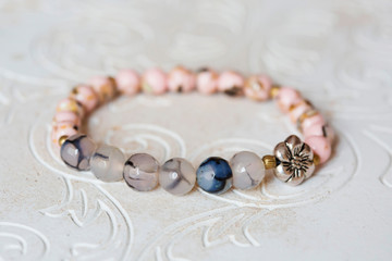 Mineral stone bracelet on natural neutral decorative background