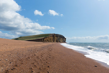Freshwater Bay Dorset with beach waves and sandstone cliffs