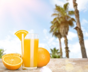 Orange juice and slices of orange on background