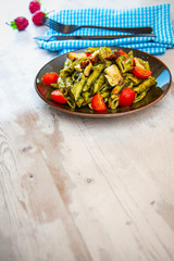 Penne cooked cereal specialty with cooked chicken fillets and a sauce made with olive oil