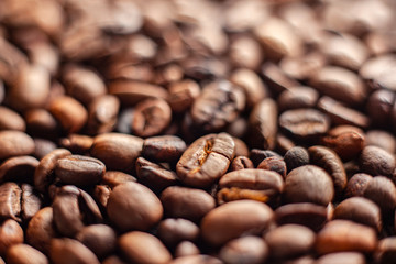 Selective focus on roasted brown coffee beans, can be used as a background and texture. Coffee beans on the table background texture. Background full of coffe beans studio shoot.
