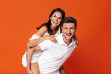 Naklejka premium Attractive young couple standing isolated