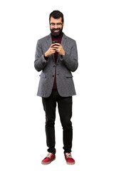 Handsome man with glasses sending a message with the mobile over isolated white background