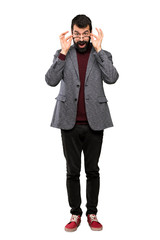 Handsome man with glasses with glasses and surprised over isolated white background