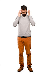 Handsome man with headache over isolated white background