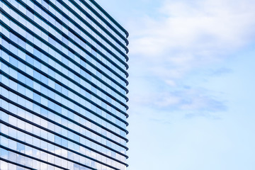 Modern beautiful building with mirrored windows. Cityscape on a warm summer evening. Concept of background or cityscape. Architectural project