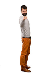 Handsome man points finger at you with a confident expression over isolated white background