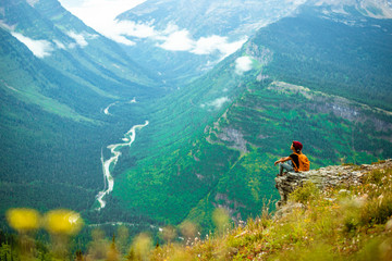 hiker on top of mountain in mountains