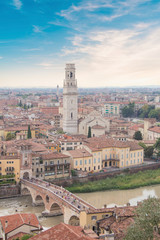 Fototapeta na wymiar Beautiful view of the Lamberti Tower and Ponte Pietra on the banks of the Adige River in Verona, Italy