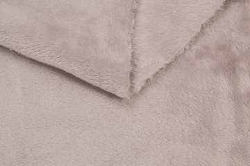 The blanket of furry fleece fabric. A background soft plush fleece material with a lot of relief folds