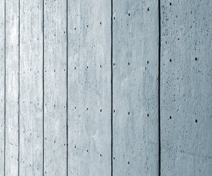 a perspective view of a large blue textured concrete wall with black vertical lines and a pattern of repeating dots