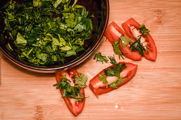 Fresh tomato slices on wood background