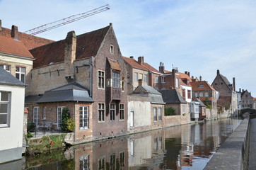 Bruges, Belgium. Image with Rozenhoedkaai in Brugge, Dijver river canal twilight and Belfort (Belfry) tower.