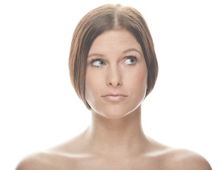 portrait of a young woman in front of a bright background thinking 